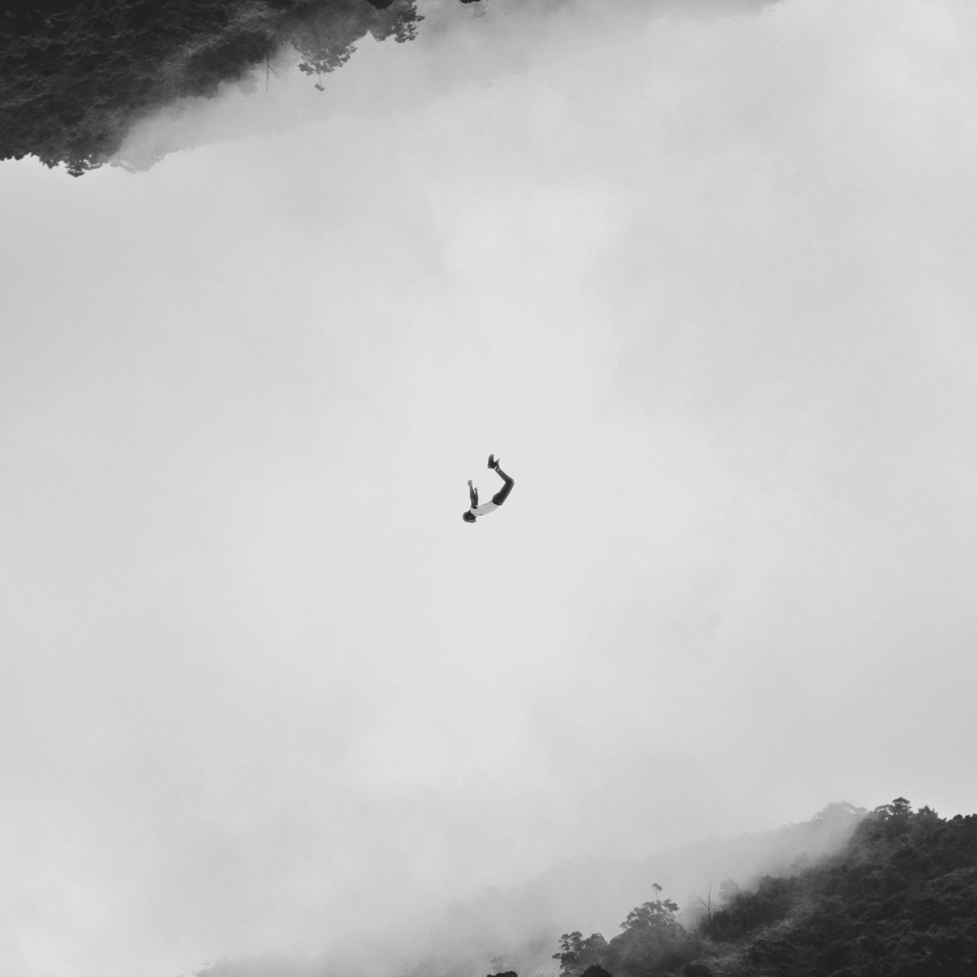 A figure suspended weightless in soft mist